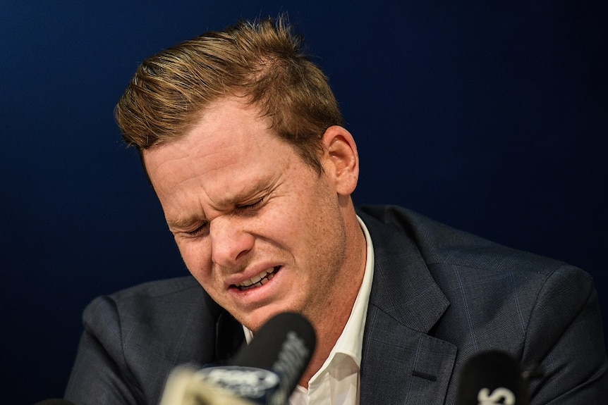 Cricketer Steve Smith looks pained in front of press conference