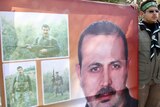 A Hamas support holds a picture of Al Mabhouh at his funeral in Syria.