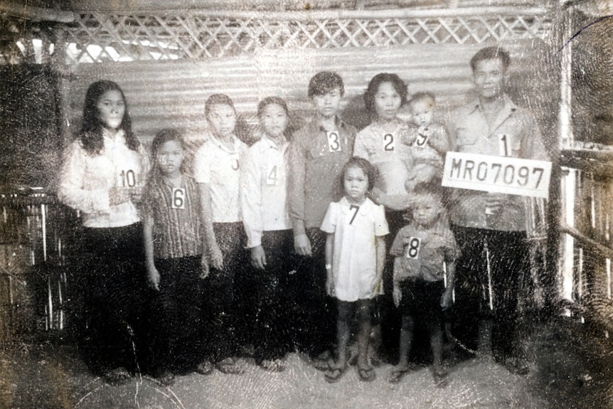 Picture in B&W of Cambodian household with numbers from Khmer Rouge camp.
