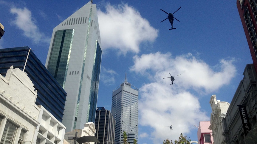 Helicopters fly over Perth in the Operation Slipper parade