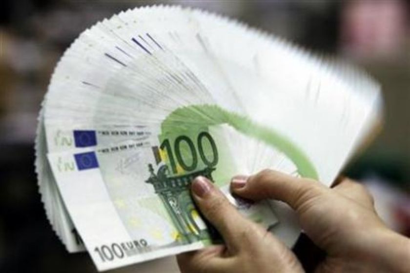 Euro notes fanned in a hand (Reuters)