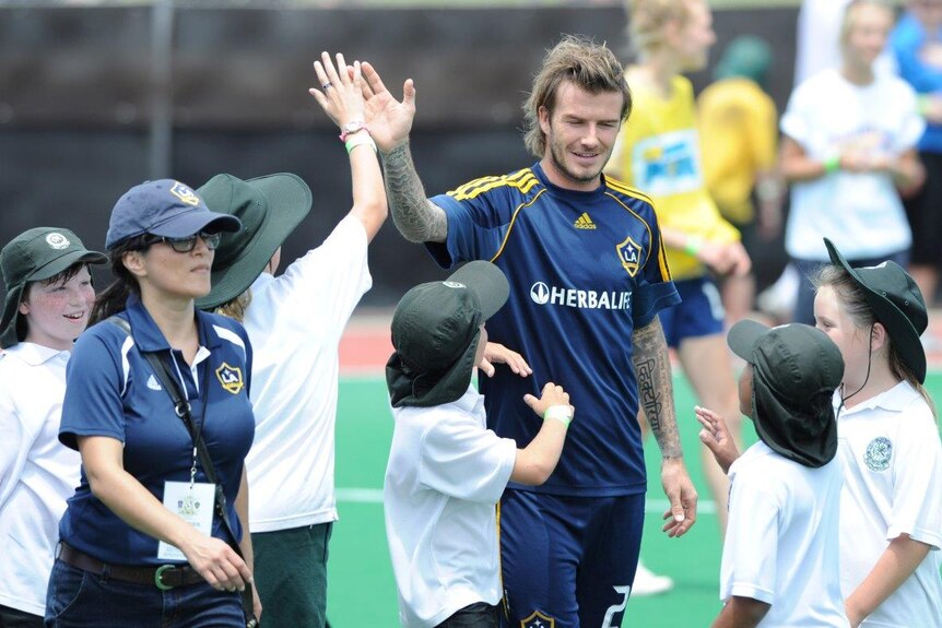 David Beckham high fives local school children
