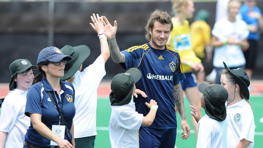 David Beckham high fives local school children