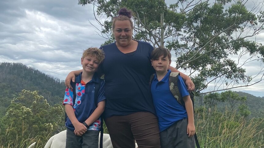 Janet with her arms around her two sons, aged 9 and 10.