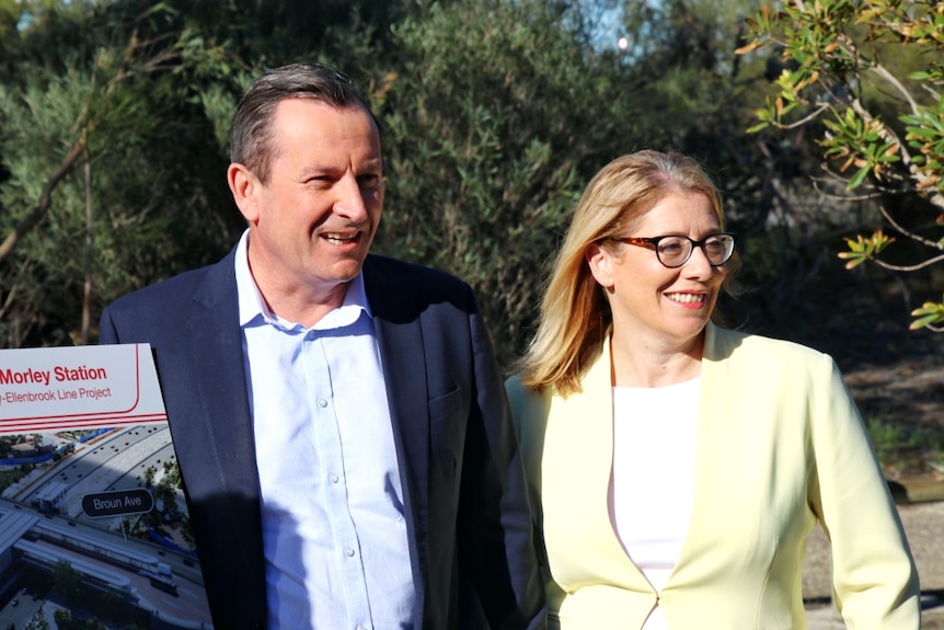 Premier Mark McGowan wearing a navy jacket and pale blue shirt stands next to Rita Saffioti, who wears a lemon jacket.
