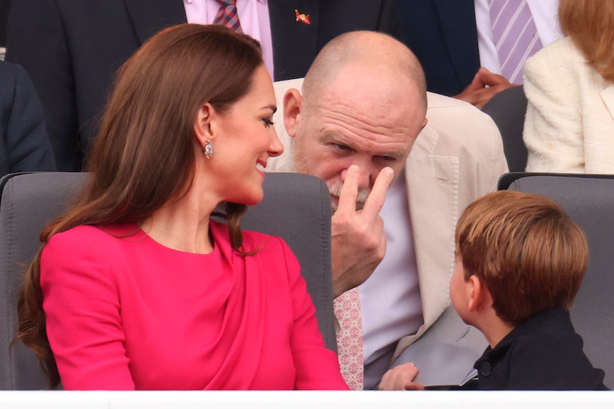 Prince Louis' uncle Mike Tindall makes a 'I'm looking at you' gesture at him jokingly. 