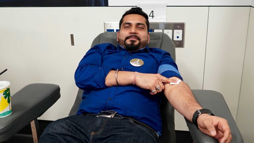 Man donates blood at the Red Cross blood donation centre in Sydney