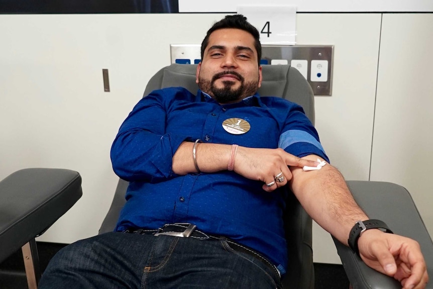 Man donates blood at the Red Cross blood donation centre in Sydney