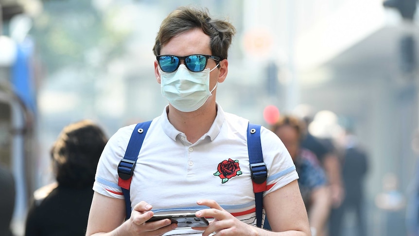 A man wears a dust mask