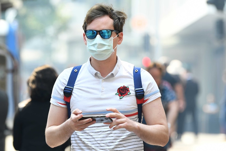 A man wears a dust mask