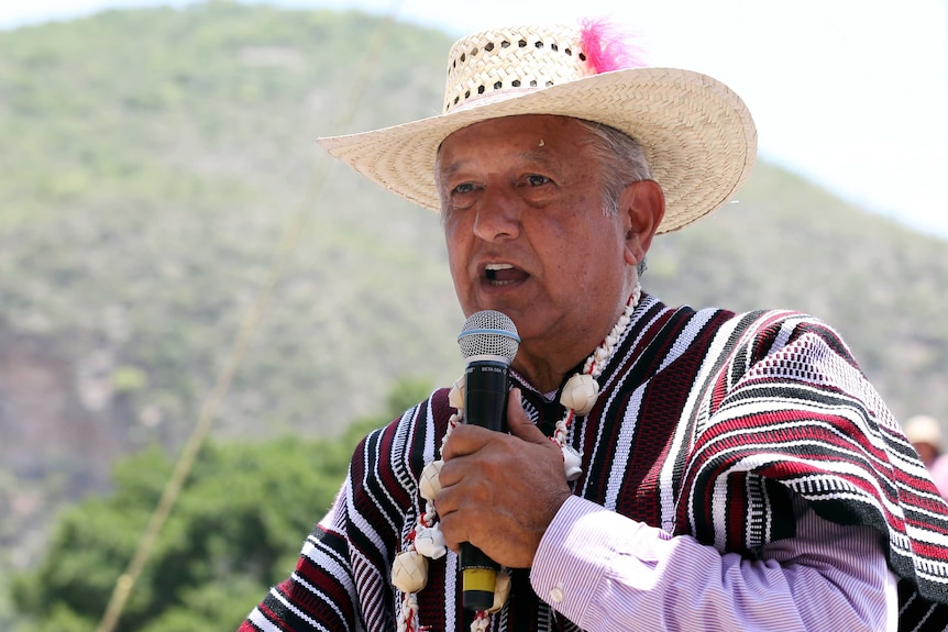 AMLO in a hat and poncho