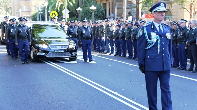 NSW Police Commissioner Andrew Scipione leads the marching escort ahead of Senior Constable Tony Tamplin's coffin.