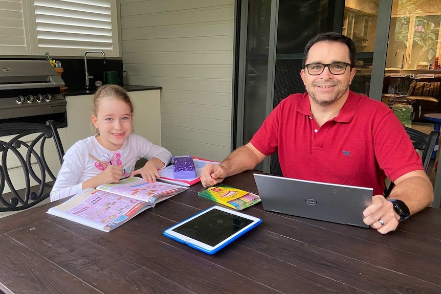 Charlotte and Julian Bailey sit outside doing homework.