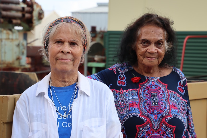 Two older Aboriginal women looking at the camera with neutral expressions.