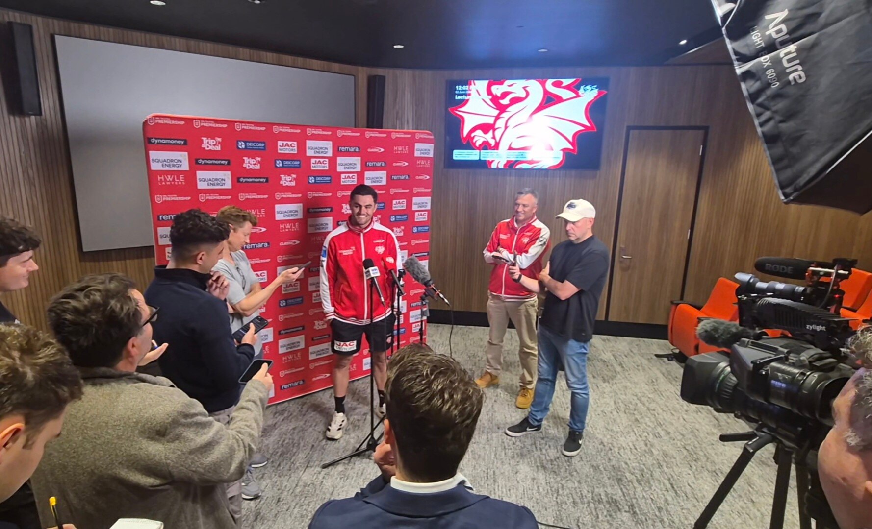 Photo of a press conference with some football players