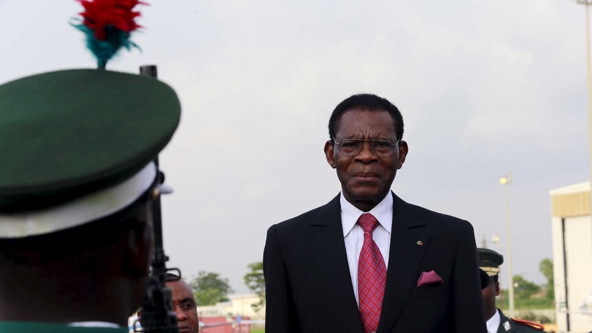 Teodoro Obiang stands in a suit.