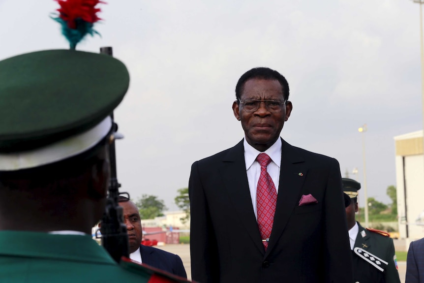 Teodoro Obiang stands in a suit.