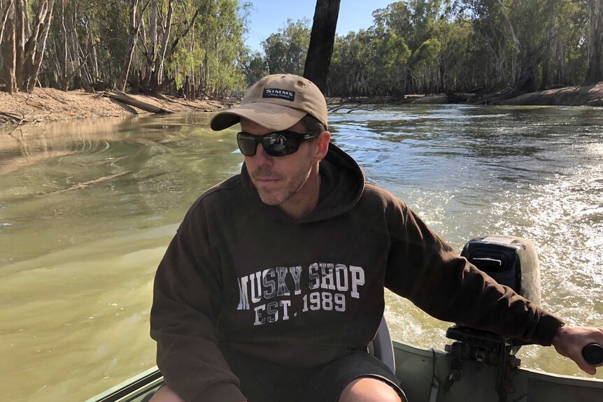 Man driving boat up a river in Australia