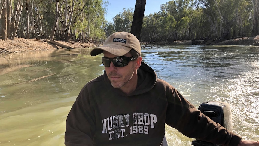 Man driving boat up a river in Australia