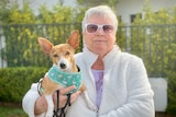 Kathryn Firth holding her little dog and both looking at the camera