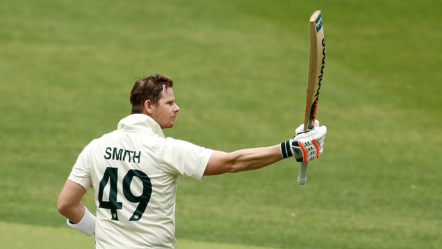 Steve Smith holds up his bat