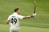 Steve Smith holds up his bat