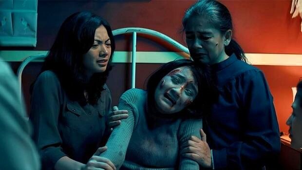 Two women were holding the woman in the middle with worried expressions.