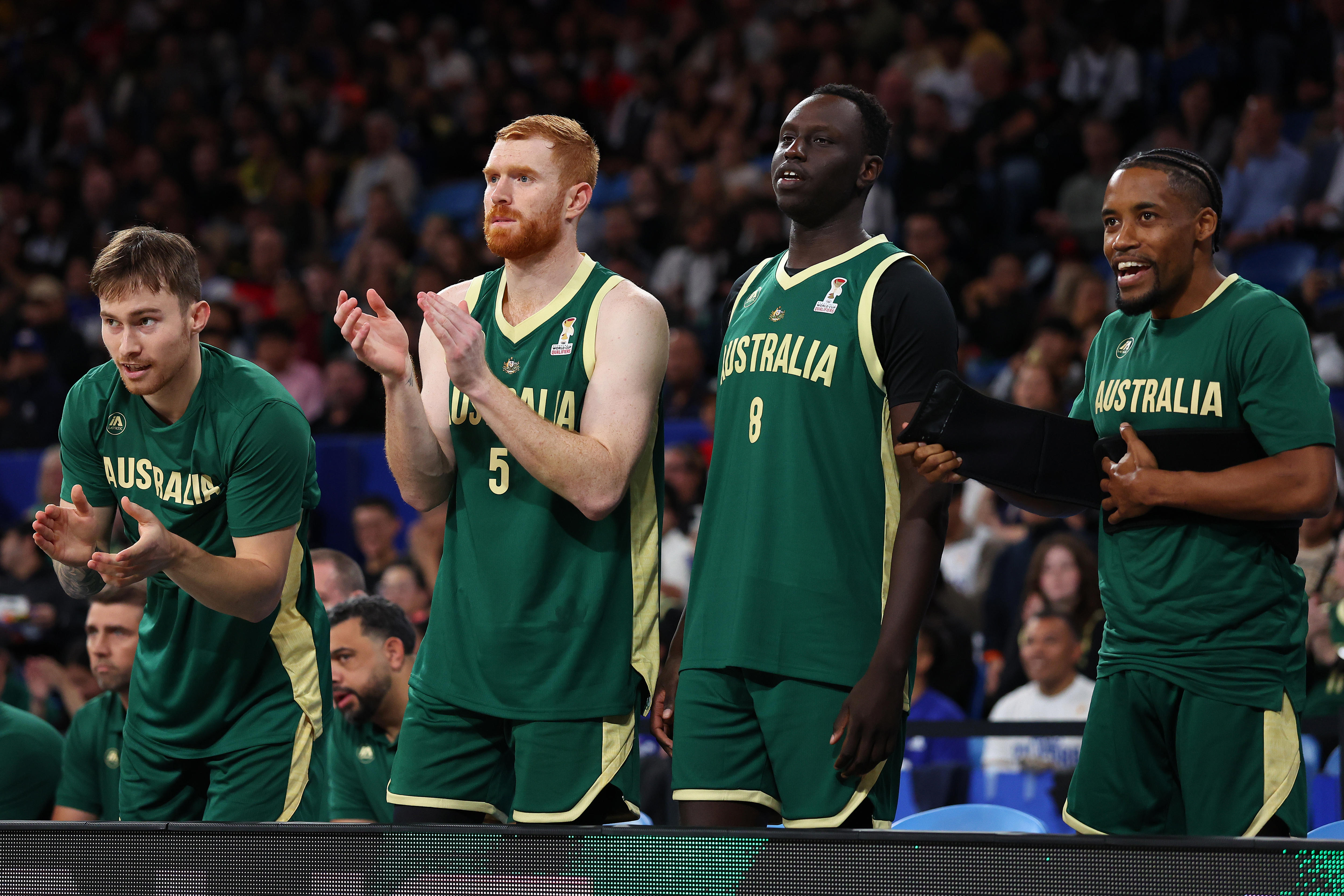Reyene Smith, Angus Glover, Wani Swaka Lo Buluk and Bryce Cotton on the sidelines of a Boomers game.