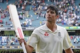 England's Alastair Cook waves his bat while walking off at stumps