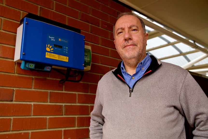 Thanasis Avramis next to his solar inverter