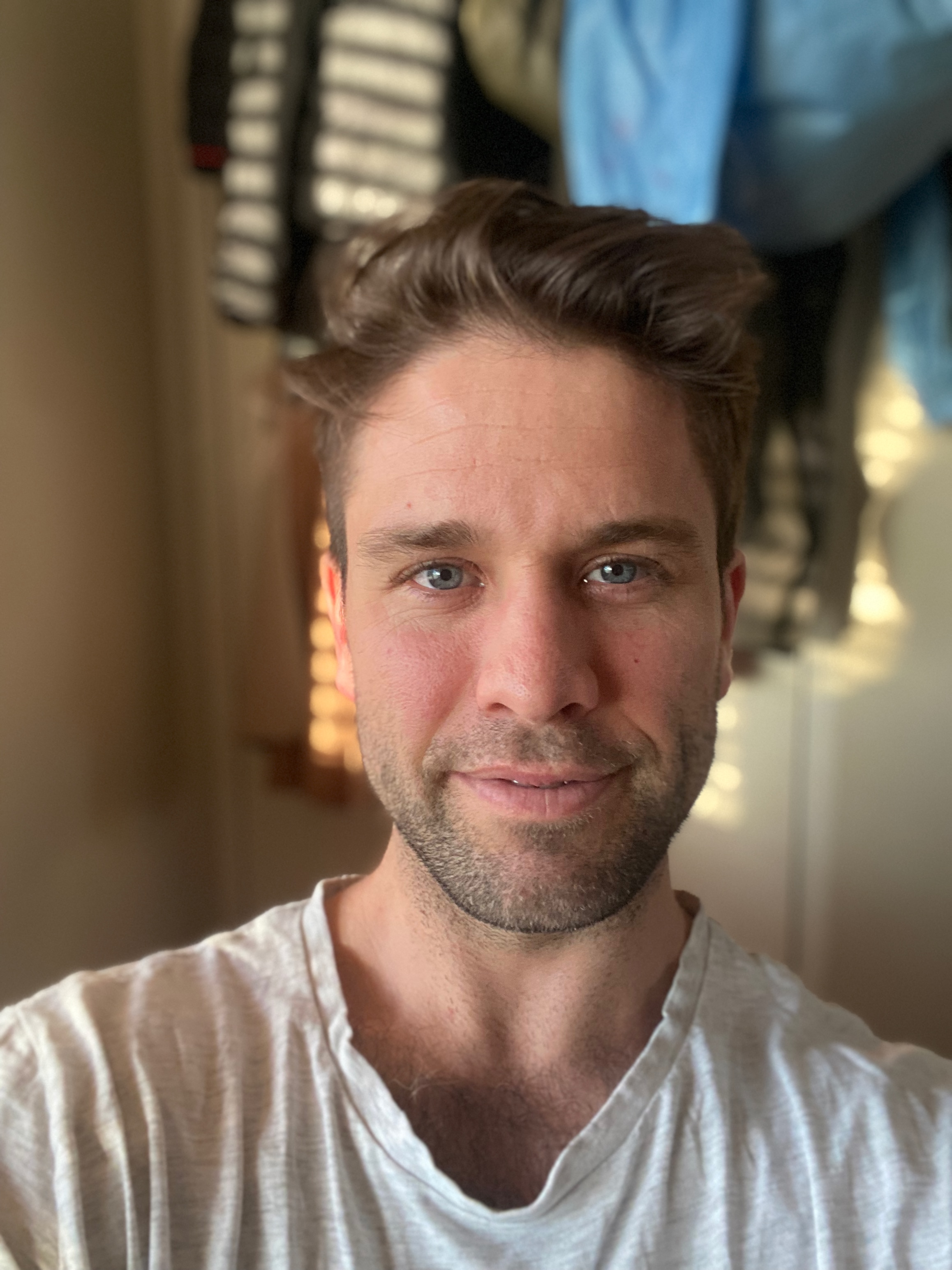 A white man taking a selfie looking at the camera.