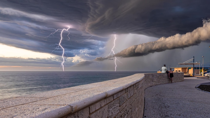Lightning strikes off the coast of a beach