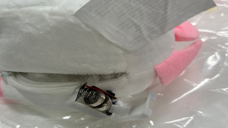 A close up of a battery attached to a backpack