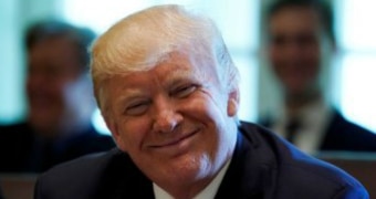 US President Donald Trump smiles during a meeting with members of his Cabinet at the White House.