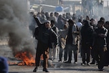 An Afghan youth shouts anti-US slogans