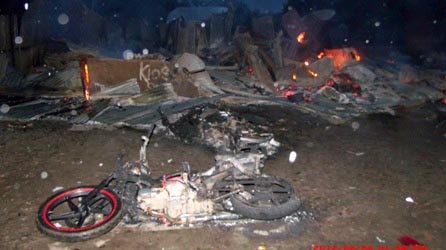 Burnt motorbike and building at Wamena in the Baliem Valley in Indonesia’s Papua province.