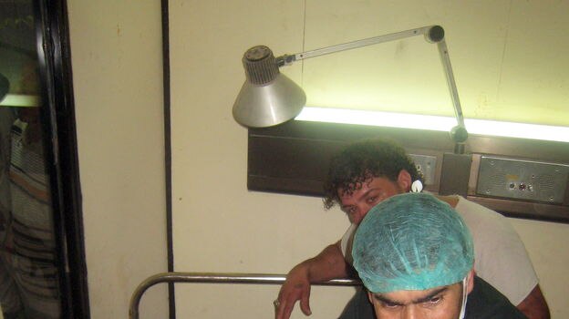 A medic looks after an injured man at the Kadhimiya Hospital