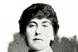 A black and white early 20th century head shot of an unsmiling woman in a high collar