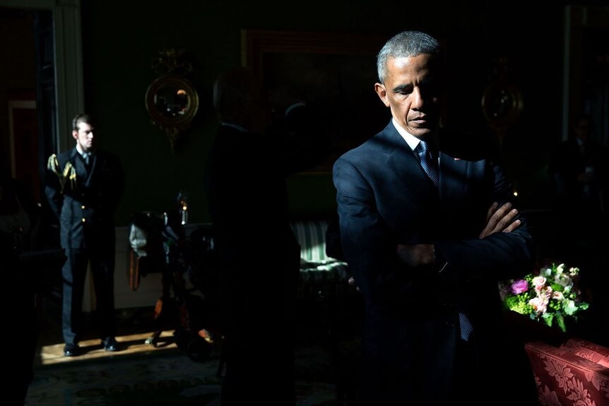 President Obama listens to his introduction in a Green Room