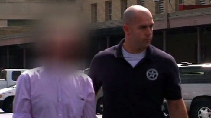 A still of Mosman bomb fraud suspect Paul Douglas Peters as he is led from a US court in  Louisville