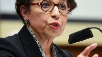 Jovita Carranza speaking in a microphone