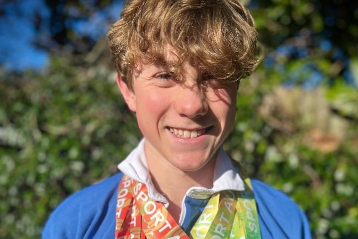 Declan Budd after swim competition with gold, bronze and silver medals around his neck. Ausnew Home Care, NDIS registered provider, My Aged Care