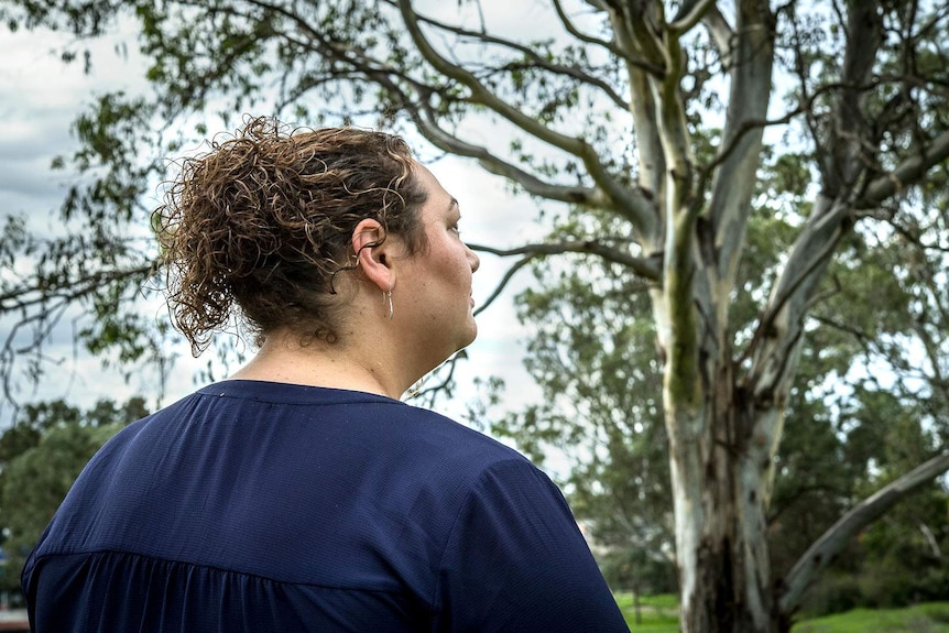 Image of sexual assault survivor Natalie facing away from the camera