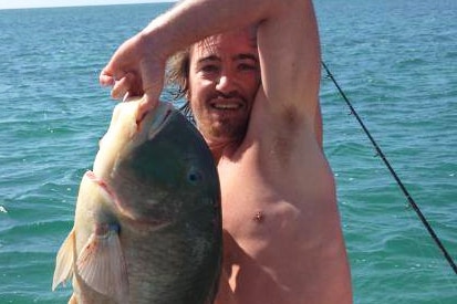 Fisherman Chad Fairley holds a fish