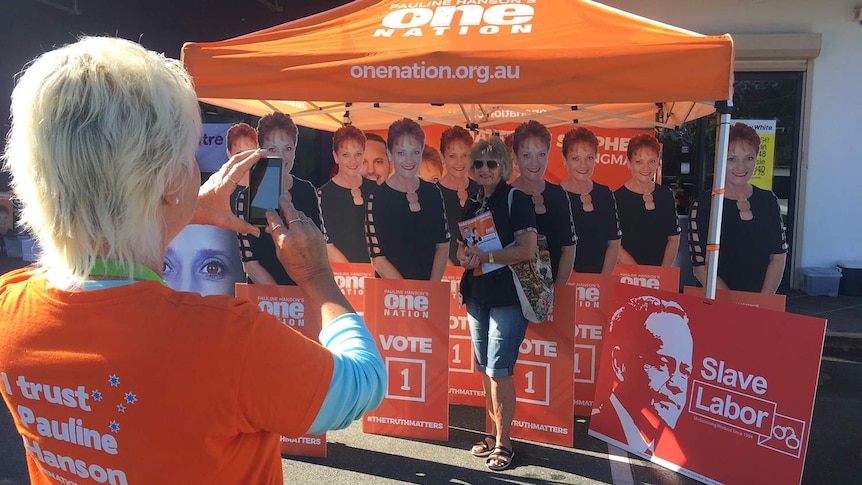 Longman resident Patricia Rogers gets at photo in front of a cardboard cut-out of One Nation Leader Pauline Hanson.
