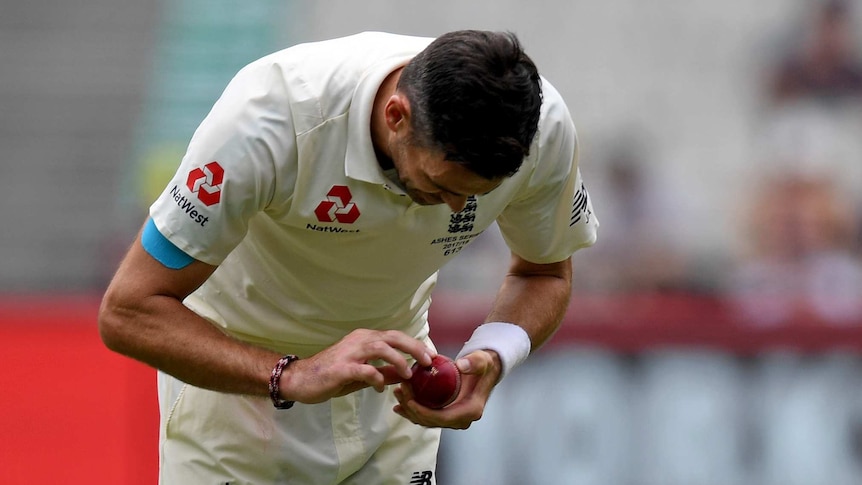 James Anderson examines the ball at the MCG