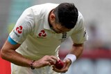 James Anderson examines the ball at the MCG