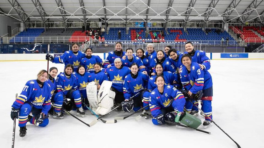 All members of the Philippines women's ice hockey team pose together on the ice for a team photo.