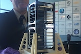 Professor Iver Cairns of University of Sydney holding one of the Australian made cube satellites