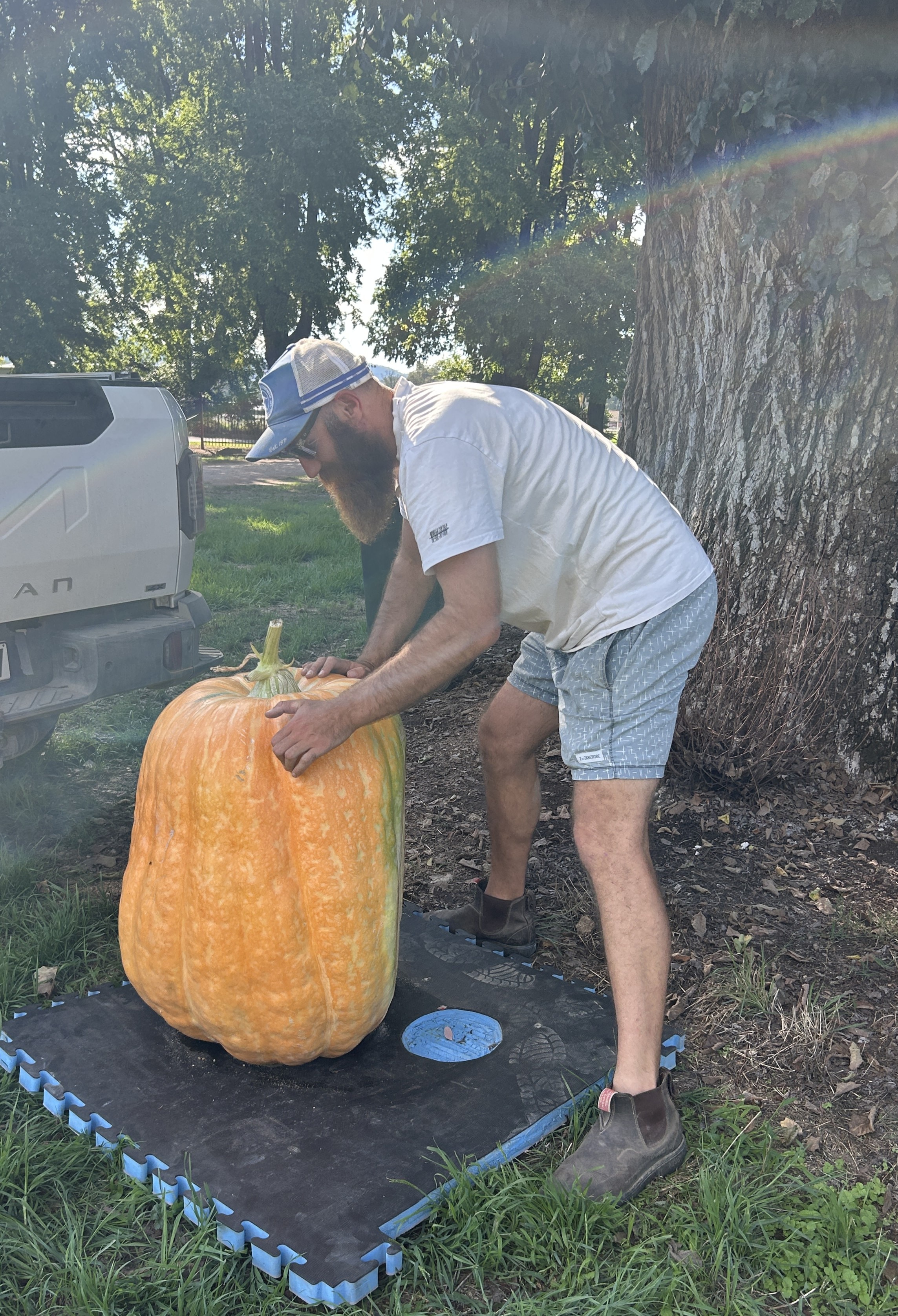 El hombre maniobra una calabaza y usa una gorra de béisbol. 